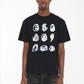 Male model wearing a black cotton T-shirt with a white abstract graphic design, styled for a contemporary casual outfit.