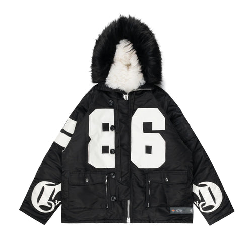 Black parka jacket featuring a faux fur-lined hood, bold white 86 design on the front, CRVDAE branding on the sleeves, and multiple utility pockets for a stylish winter look.
